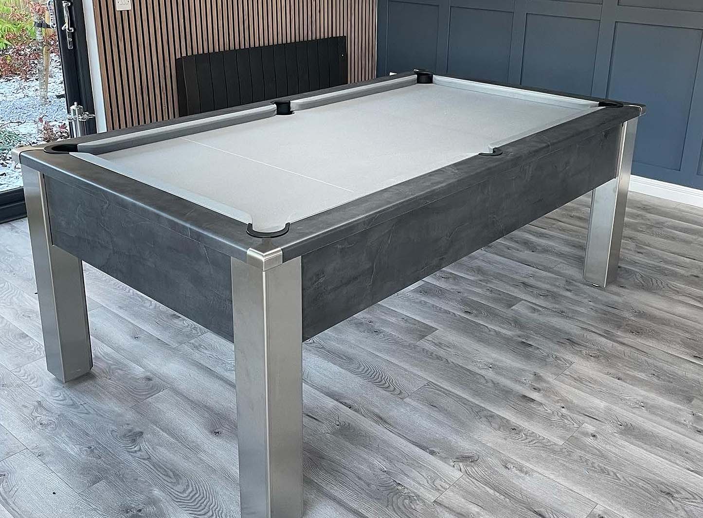 dark grey pool table with light grey cloth