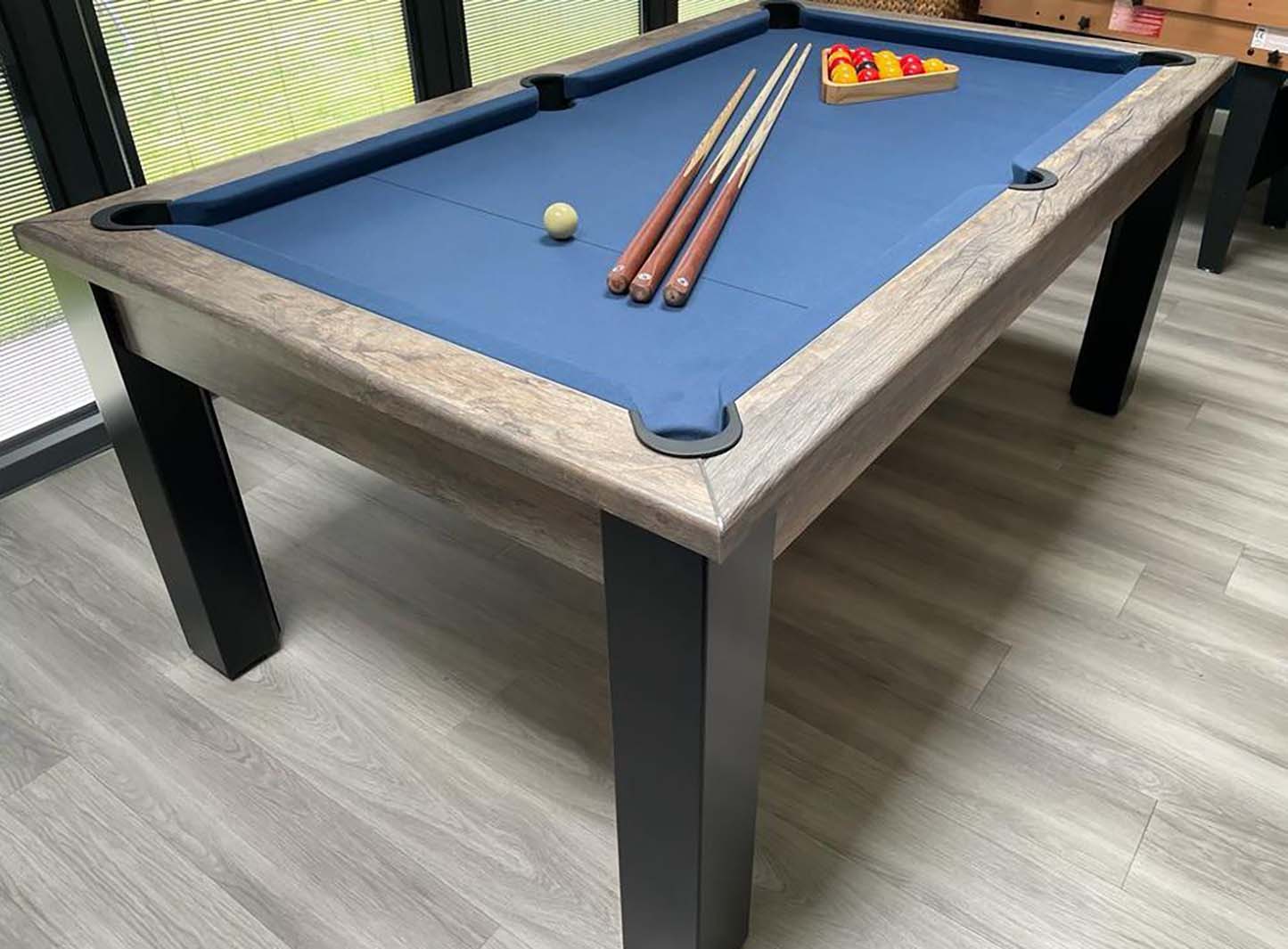 Pool table with blue felt cloth