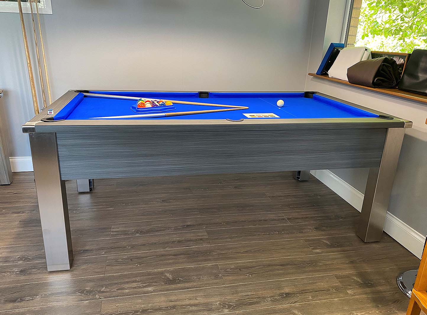 side view of a grey pool table and royal blue cloth