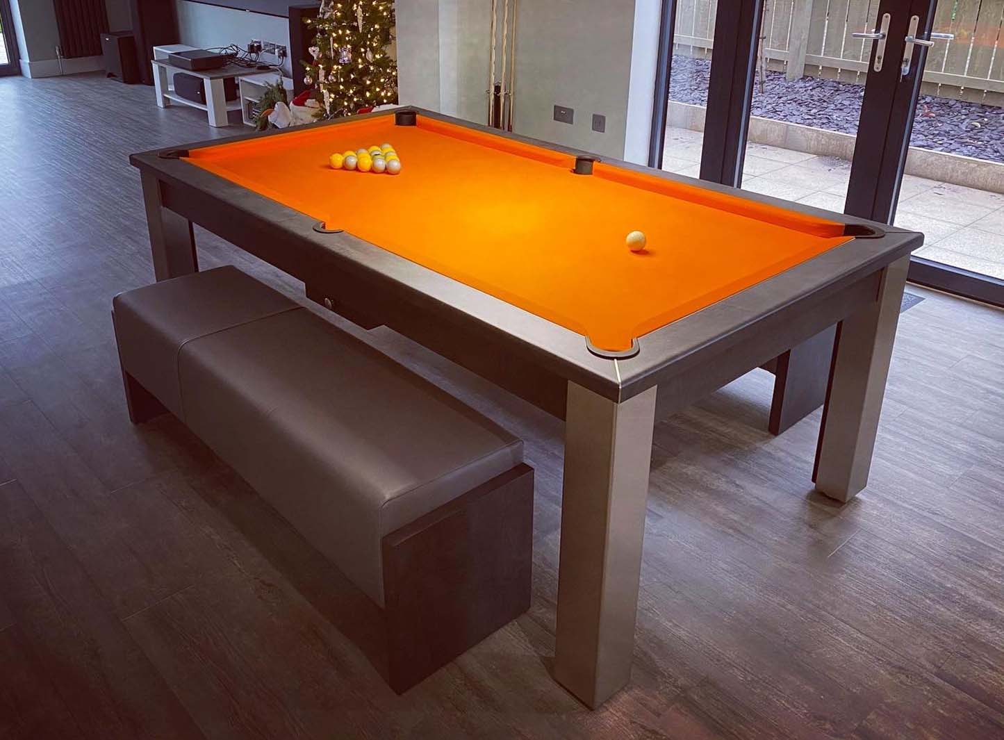 Orange cloth and grey pool table with matching benches