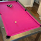 Silver and black pool balls and pink cloth felt