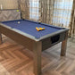 games room with a bar and pool table with blue cloth