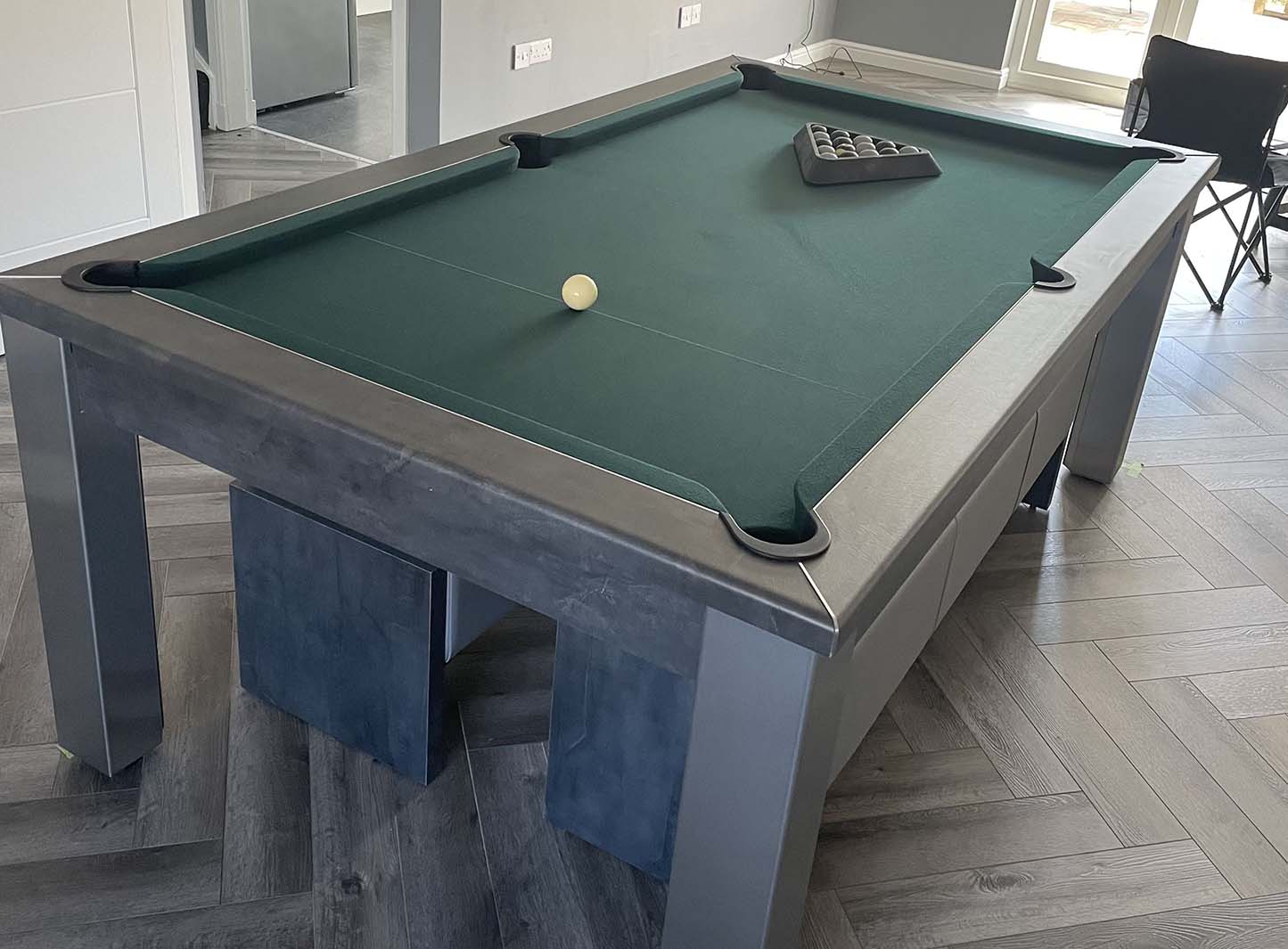 Dark green cloth and dark grey pool table and matching benches