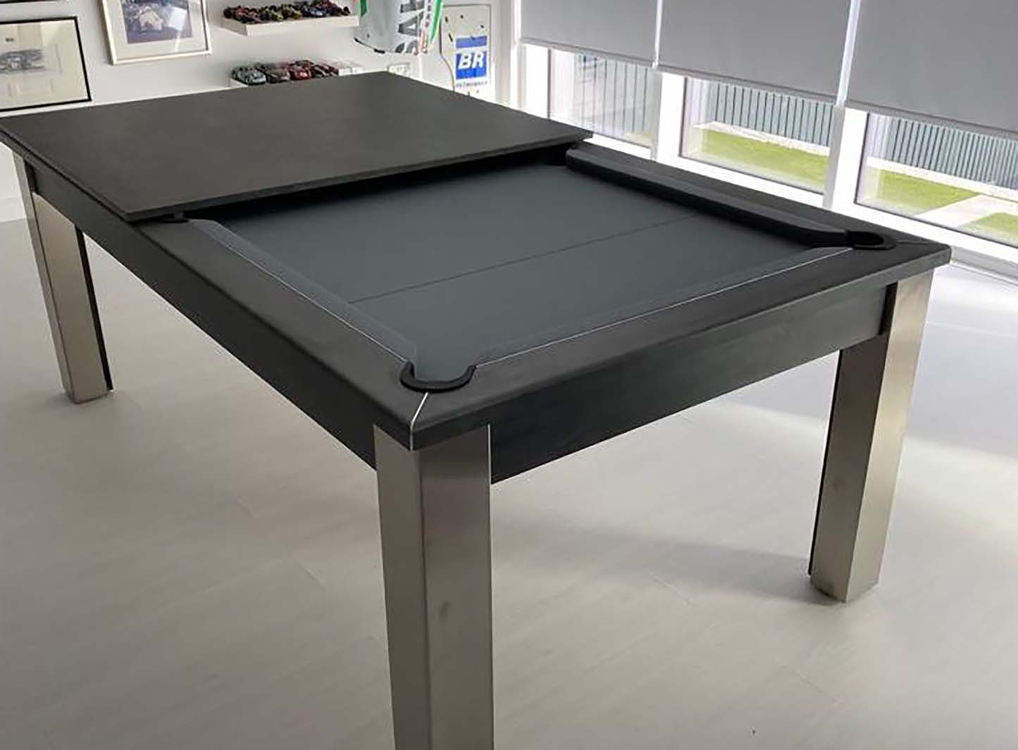 Dark grey pool table semi-covered