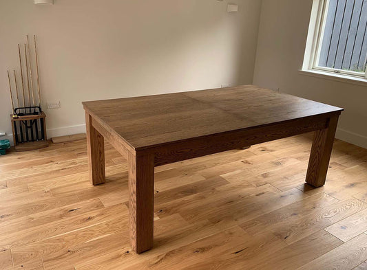 Dining table configuration in games room in farmhouse oak