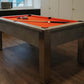 dark grey concrete style pool table in a games room with orange cloth