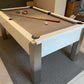 gloss white framed pool table with light grey cloth cues and balls