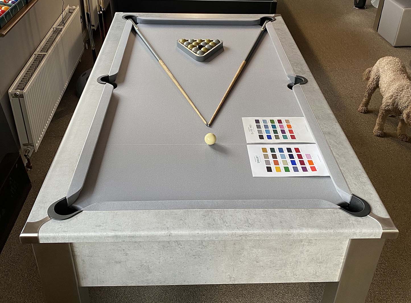 concrete style pool table with light grey cloth in a showroom