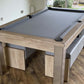 Pool table with grey cloth and matching banches doubles up as a dining table