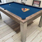 Mid blue cloth pool table in a rustic games room