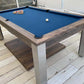 Mid blue cloth pool table in a rustic games room