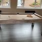 Light tan cloth pool table in a modern games room