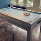 Distressed oak framed pool table with spots and stripes balls and light green cloth