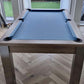 Pool table with grey cloth and matching banches doubles up as a dining table