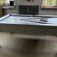 side view of a grey pool table