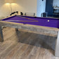 Purple cloth pool table cues and white ball