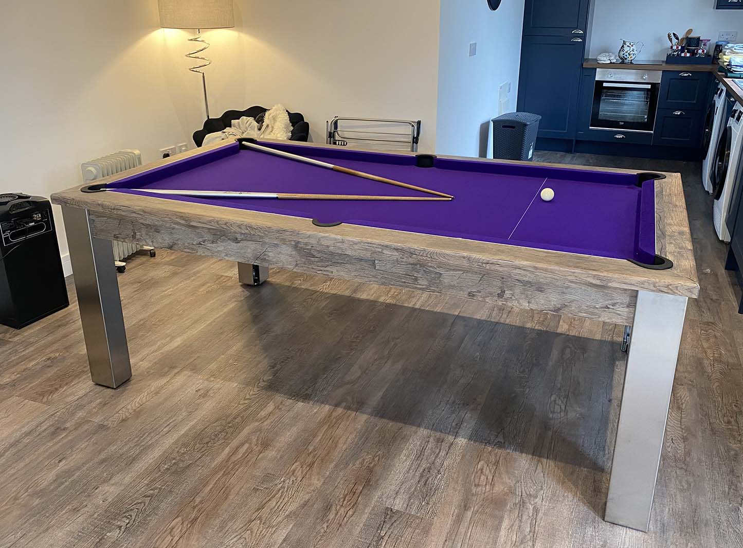 Purple cloth pool table cues and white ball