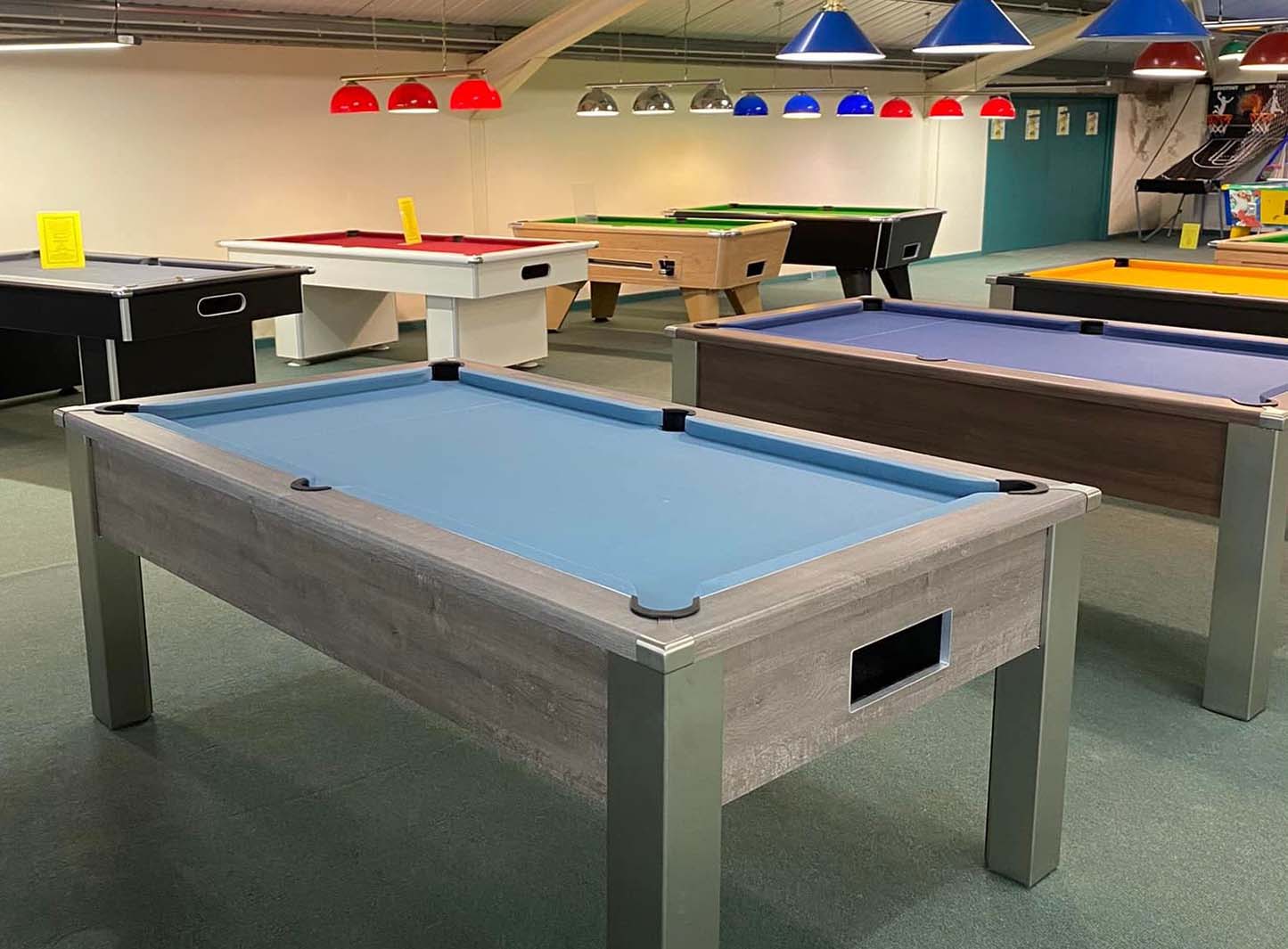 Pool table showroom with table lights various coloured cloths