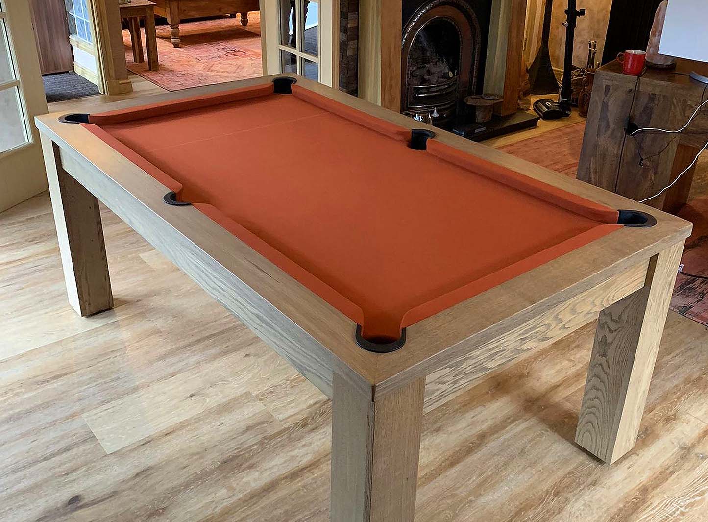 salmon coloured cloth on a rustic pool table