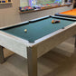 a pool table with dark green cloth spots and stripes balls and light grey body