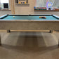 side view of a grey pool table with a green cloth setup ready to play